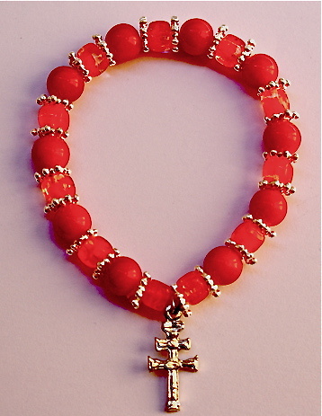 PULSERA CRUZ DE CARAVACA ELASTICA CON CORONITAS DORADAS NARANJA 